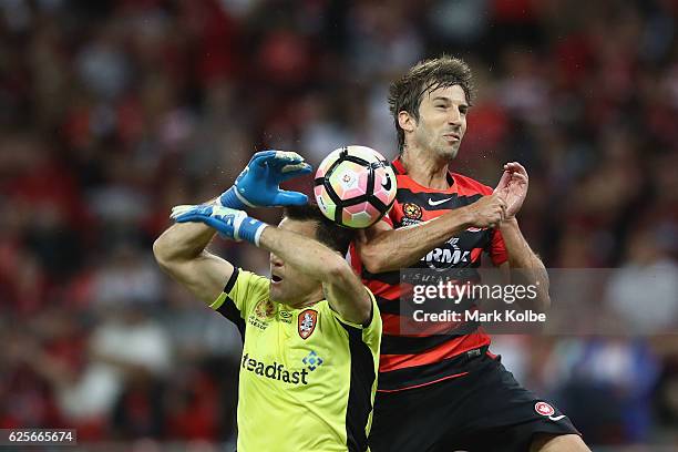 Roar goal keeper Michael Theo and Artiz Borda of the Wanderers compete for the ball in the air during the round eight A-League match between the...