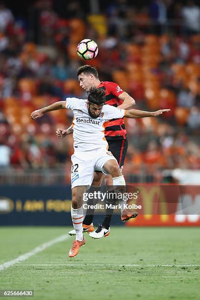 Scott Neville of the Wanderers and Brett Holman of the Roar compete for the ball in the air during the round eight A-League match between the Western...