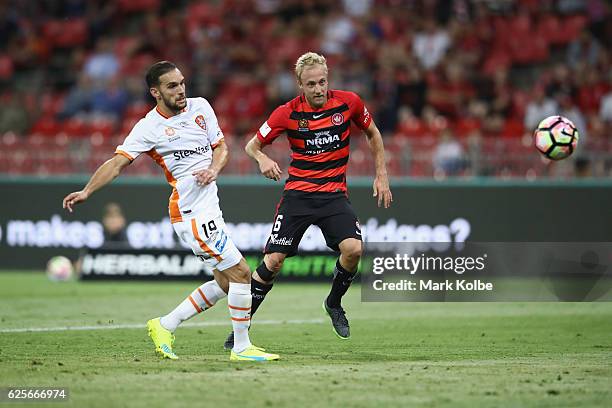 Mitch Nichols of the Wanderers shoots at goal under pressure from Jack Hingert of the Roar during the round eight A-League match between the Western...