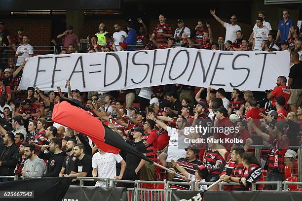 Wanderers supporters in the Red and Black Block hold up a banner during the round eight A-League match between the Western Sydney Wanderers and the...