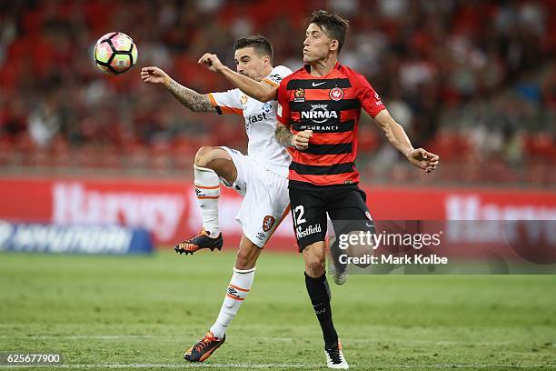 Jamie Maclaren of the Roar and Scott Neville of the Wanderers compete for the ball during the round eight A-League match between the Western Sydney...