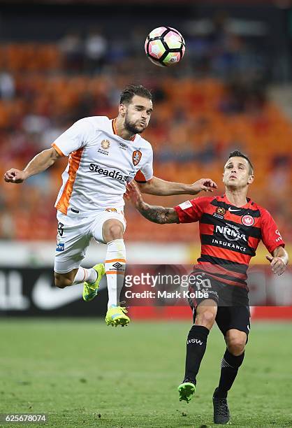 Jamie Maclaren of the Roar heads the ball over Nicolas Martnez of the Wanderers during the round eight A-League match between the Western Sydney...