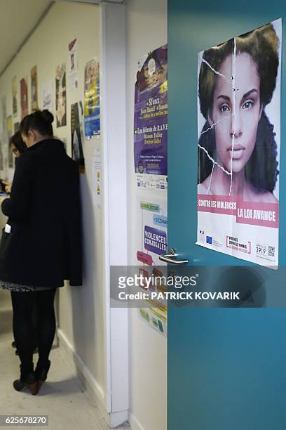 Poster reading "Towards violences, the law improves" is pictured at the French Fédération Nationale Solidarité Femmes on November 25, 2016 in Paris,...