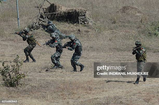 Soldiers from Indian Army and Peoples Liberation Army of China participate in an anti-terror drill during the validation exercise of the Sixth...