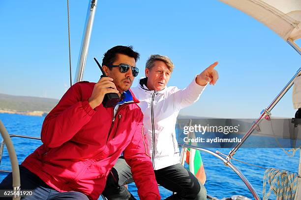 seniors skipper sailing with sailboat - yacht crew stock pictures, royalty-free photos & images