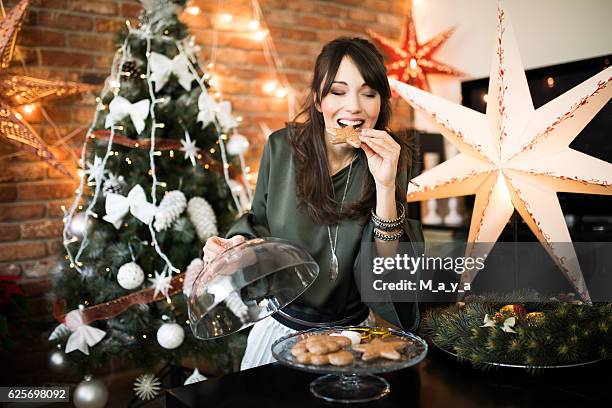 delicious christmas sweets - ethnic woman at christmas stock pictures, royalty-free photos & images