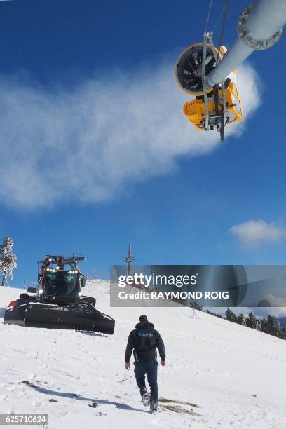 An employee of the ski resort of Font-Romeu, southern France, controls a snow gun on November 25, 2016 prior to the opening of ski hills.