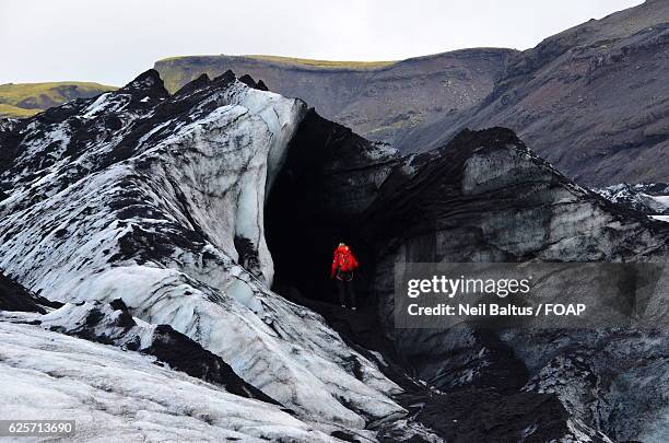 person hiking on solheimajokull glacier - baltus stock pictures, royalty-free photos & images