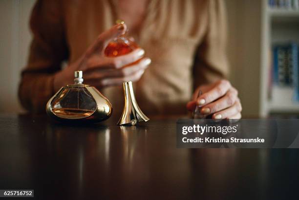 woman applying perfume - perfume sprayer bildbanksfoton och bilder