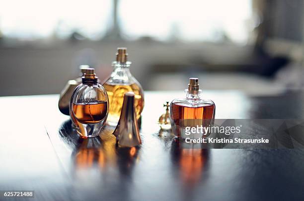 four perfume bottles - borrifador de perfume imagens e fotografias de stock
