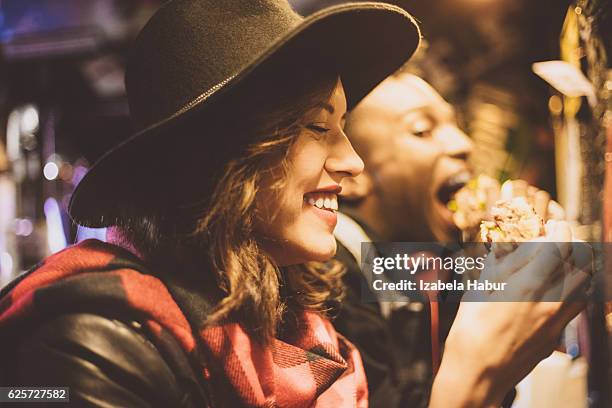 beautiful young woman in burger pub - woman eating burger stock pictures, royalty-free photos & images