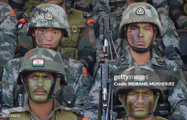 Soldiers from the Indian Army and People's Liberation Army sit together after participating in an anti-terror drill during the Sixth India-China...