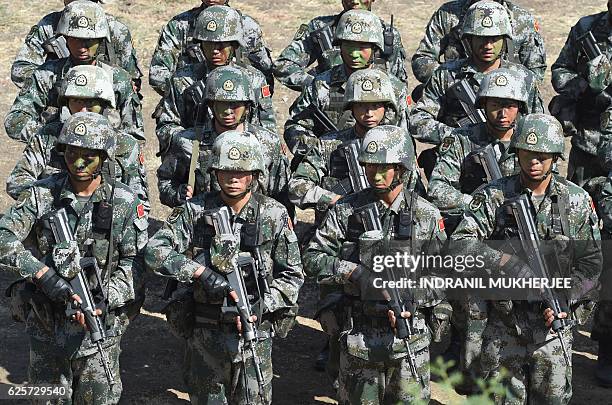 People's Liberation Army of China soldiers line up after participating in an anti-terror drill during the Sixth India-China Joint Training exercise...