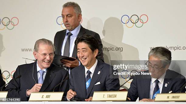 Argentina - International Olympic Committee President Jacques Rogge and Japanese Prime Minister Shinzo Abe chat as Tokyo bid chief Tsunekazu Takeda...