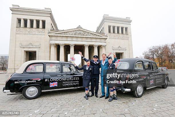 David Hasselhoff and a British Airways pilot pose next to uBA London taxis during a competition to launch the British Airways London for Less Sale on...