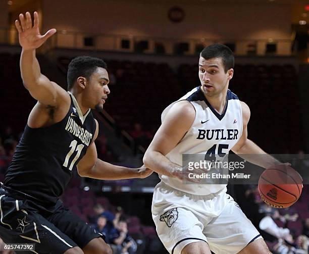 Andrew Chrabascz of the Butler Bulldogs is guarded by Jeff Roberson of the Vanderbilt Commodores during the 2016 Continental Tire Las Vegas...