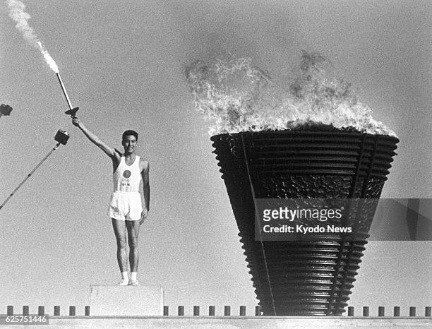 Japan - Yoshinori Sakai, the final runner in the torch relay, lights the Olympic cauldron during the opening ceremony of the Tokyo Olympics on Oct....