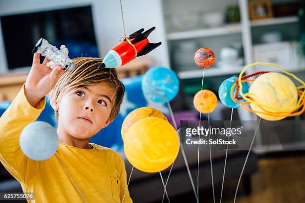 playing with his astronaut - kids playing bildbanksfoton och bilder