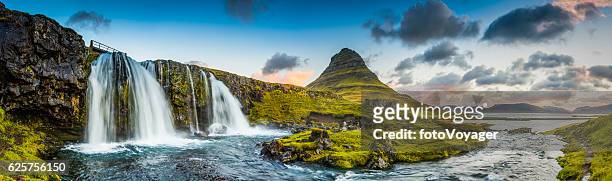 mountain waterfalls below rocky peaks panorama at sunrise kirkjufell iceland - panoramic view stock pictures, royalty-free photos & images