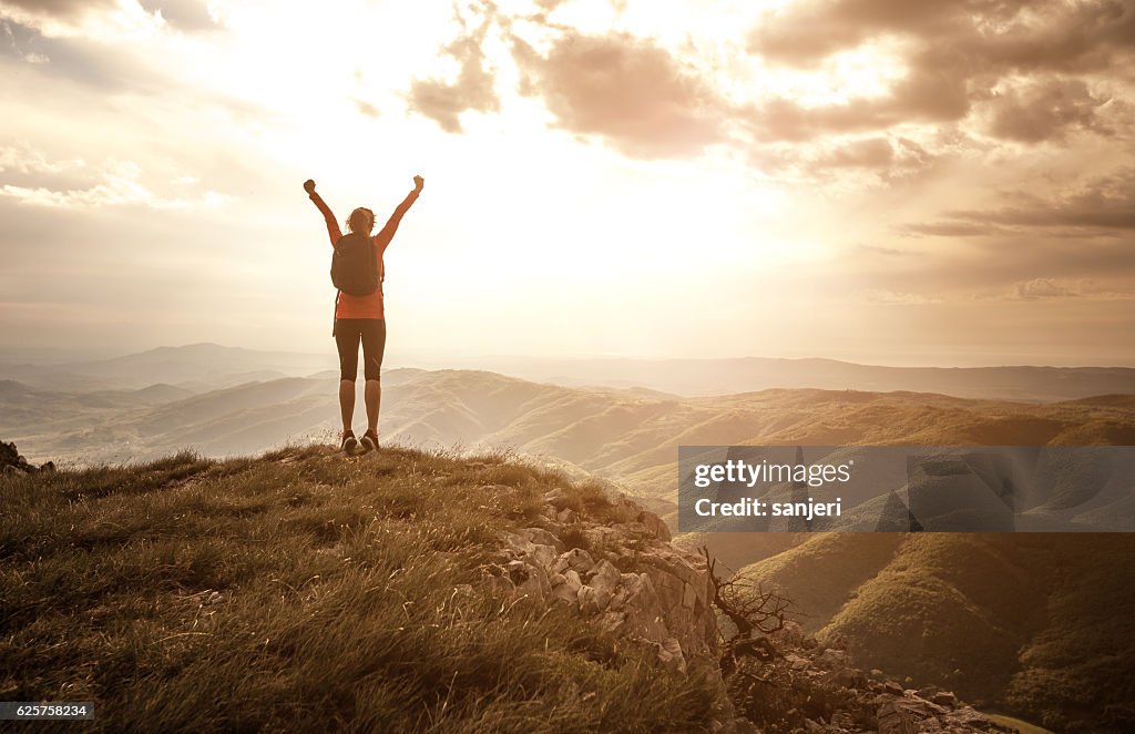 Woman Greeting the Sun on the Top of the Hill