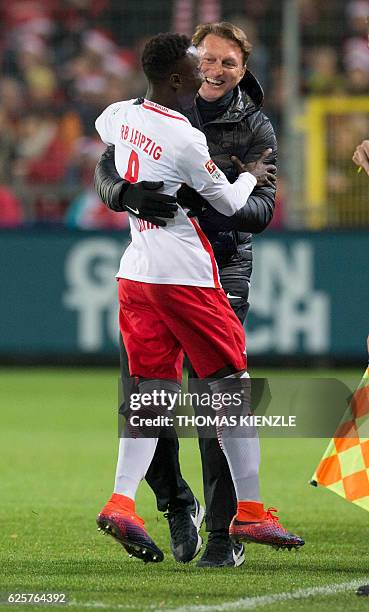 Leipzig's Guinean midfielder Naby Keita celebrates after scoring the opening goal with head coach Ralph Hasenhuettl during the German first division...