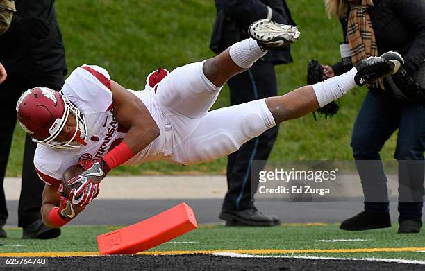 Running back Devwah Whaley of the Arkansas Razorbacks dives into the end zone for a touchdown against the Missouri Tigers in the first quarter at...