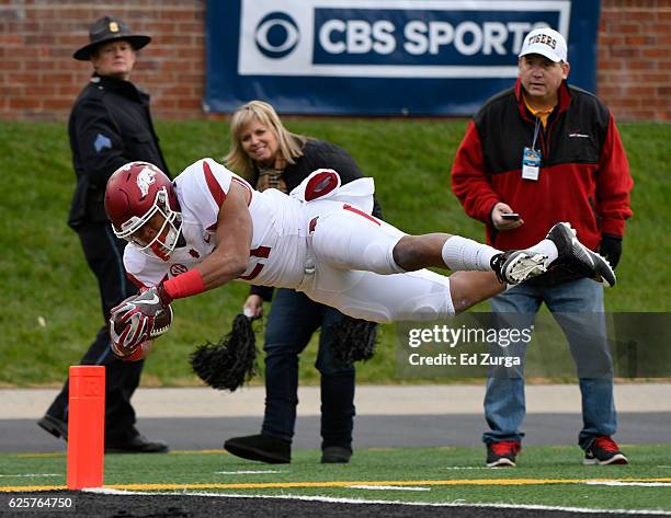 Running back Devwah Whaley of the Arkansas Razorbacks dives into the end zone for a touchdown against the Missouri Tigers in the first quarter at...
