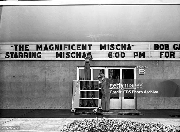 Radio program, "Mischa, The Magnificent" starring Mischa Auer. In this image Mischa Auers young son, Tony, puts up his fathers name on the CBS-KNX...