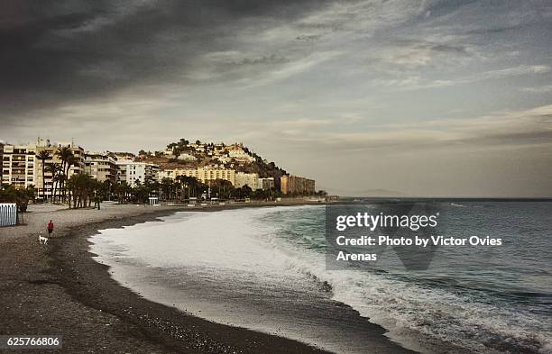 quietness on san cristobal beach after sunset in almuñecar, most important beach resort in granada, spain - almuñecar stockfoto's en -beelden