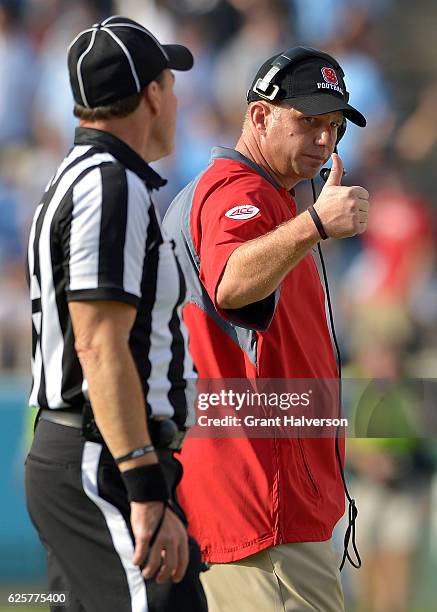 Head coach Dave Doeren of the North Carolina State Wolfpack flashes a thumbs up to the official during their game against the North Carolina Tar...