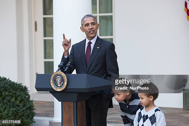 President Barack Obama stands with his nephews Austin and Aaron Robinson before he pardons the National Thanksgiving Turkey in the Rose Garden of the...