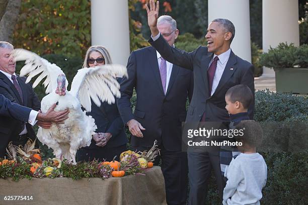 President Barack Obama pardons the National Thanksgiving Turkey, 'Tot,' with his nephews Aaron and Austin Robinson and National Turkey Federation...