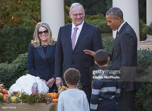 President Barack Obama stands with his nephews Austin and Aaron Robinson before he pardons the National Thanksgiving Turkey in the Rose Garden of the...
