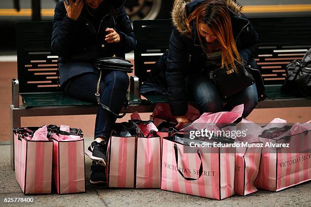 Women rest next to Victoria Secret shopping bags during Black Friday  News Photo - Getty Images