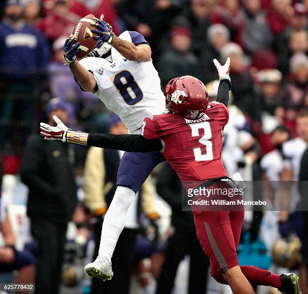 Dante Pettis of the Washington Huskies catches a pass against Darrien Molton of the Washington State Cougars in the first half of the 109th Apple Cup...