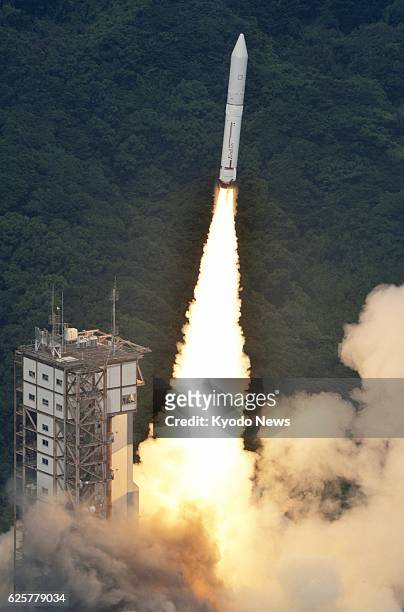 Japan - Photo taken from a Kyodo News helicopter shows Japan's new solid-fuel rocket Epsilon lifting off from the launch pad at the Uchinoura Space...