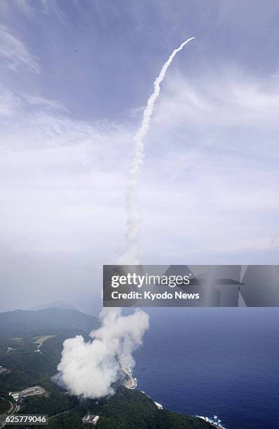 Japan - Photo taken from a Kyodo News helicopter shows white smoke left behind in the sky after Japan's new solid-fuel rocket Epsilon lifts off from...