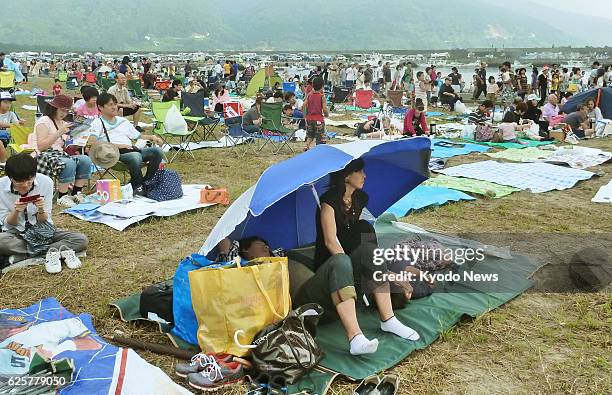 Japan - Photo shows people who have gathered in Kimotsuki, Kagoshima Prefecture, on the morning of Sept. 14 to view the liftoff that afternoon of...