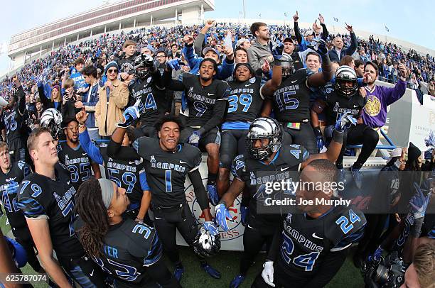 The Memphis Tigers celebrate the win with fans against the Houston Cougars on November 25, 2016 at Liberty Bowl Memorial Stadium in Memphis,...