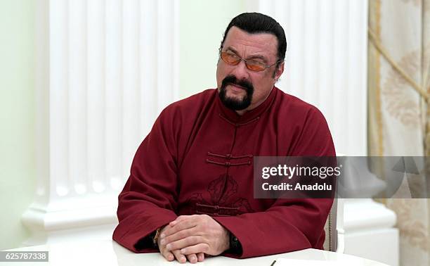 Hollywood actor Steven Seagal is seen as Russia's President Vladimir Putin hands over a Russian passport to him at Kremlin in Moscow, Russia on...