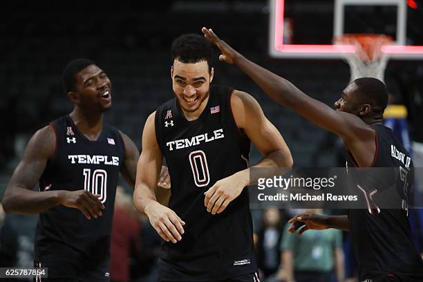 Shizz Alston Jr. #3 and Mark Williams celebrate with Obi Enechionyia of the Temple Owls after he was named All-Tournament Most Valuable Player during...