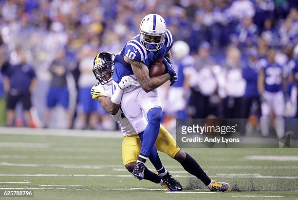 Donte Moncrief of the Indianapolis Colts runs with the ball while tackled by Sean Davis of the Pittsburgh Steelers at Lucas Oil Stadium on November...