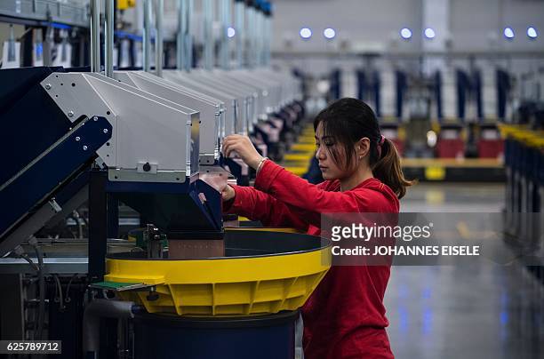 This picture taken on November 24 shows a worker checking the production in the packaging section of the newly opened Lego factory in Jiaxing. Lego's...