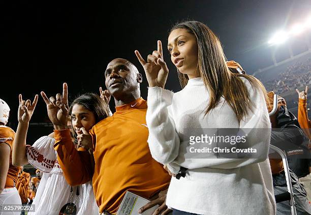 Head coach Charlie Strong of the Texas Longhorns sings "The Eyes of Texas" with his daughters after being defeated by the TCU Horned Frogs 31-9 at...
