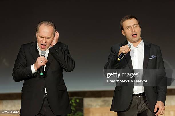 Russian baritone Vladislav Kosarev and actor Aleksei Guskov perform on stage during Russian Film Festival on November 25, 2016 in Honfleur, France.
