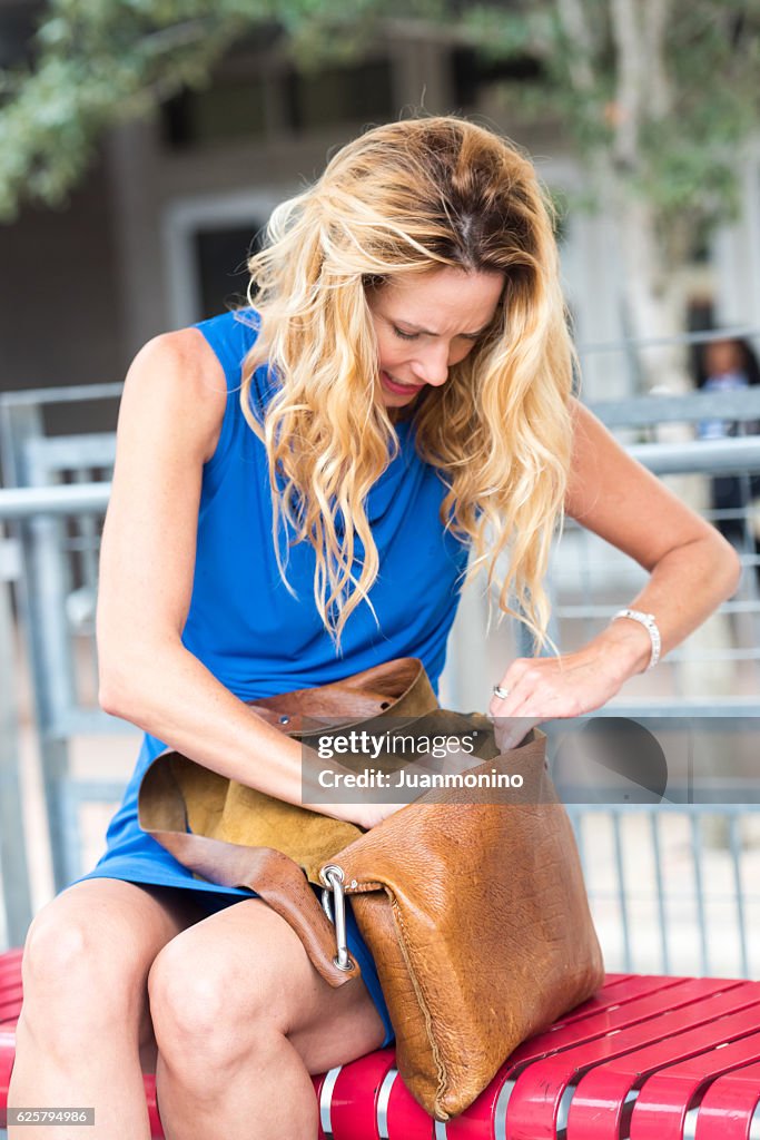 Mature women looking inside her hand bag