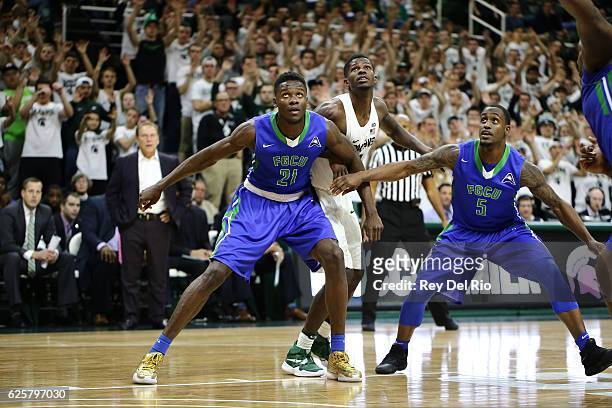 Eron Harris of the Michigan State Spartans fight for position against Demetris Morant of the Florida Gulf Coast Eagles on November 20, 2016 in East...