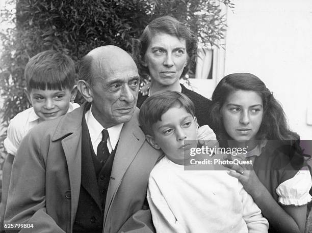 Portrait of Austrian-born American composer Arnold Schoenberg as he poses with unidentified members of his family, Los Angeles, California, 1950.