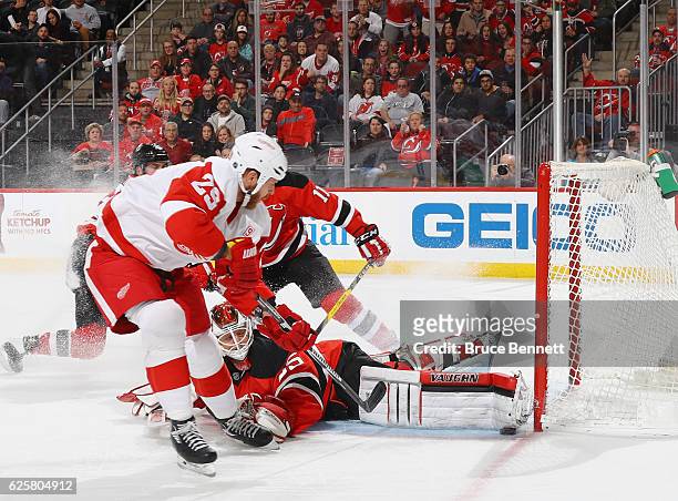 Cory Schneider of the New Jersey Devils makes the pad save on Steve Ott of the Detroit Red Wings during the first period at the Prudential Center on...