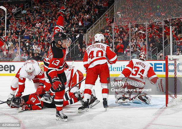 Michael Cammalleri of the New Jersey Devils celebrates his goal at 4:06 of the third period against Petr Mrazek of Detroit Red Wings at the...
